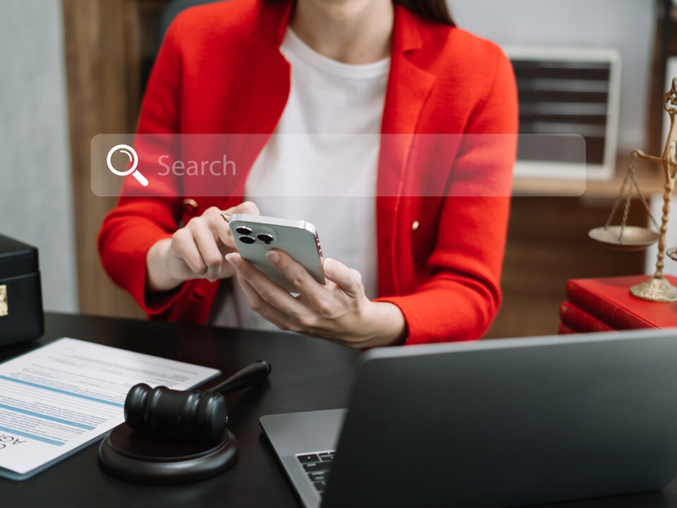 A lawyer sitting in her office, working on local SEO for lawyers using a laptop to get more legal clients